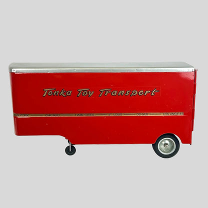Red toy transport truck with 'Tonka Toy Transport' text on a white background