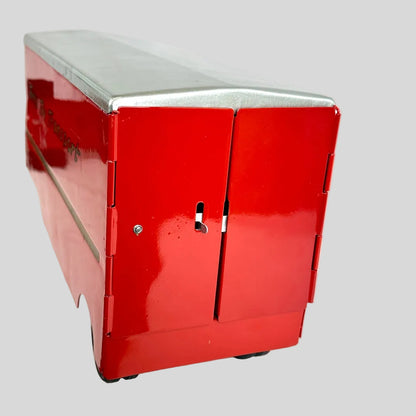 Backside of red toy transport trailer against gray background. 