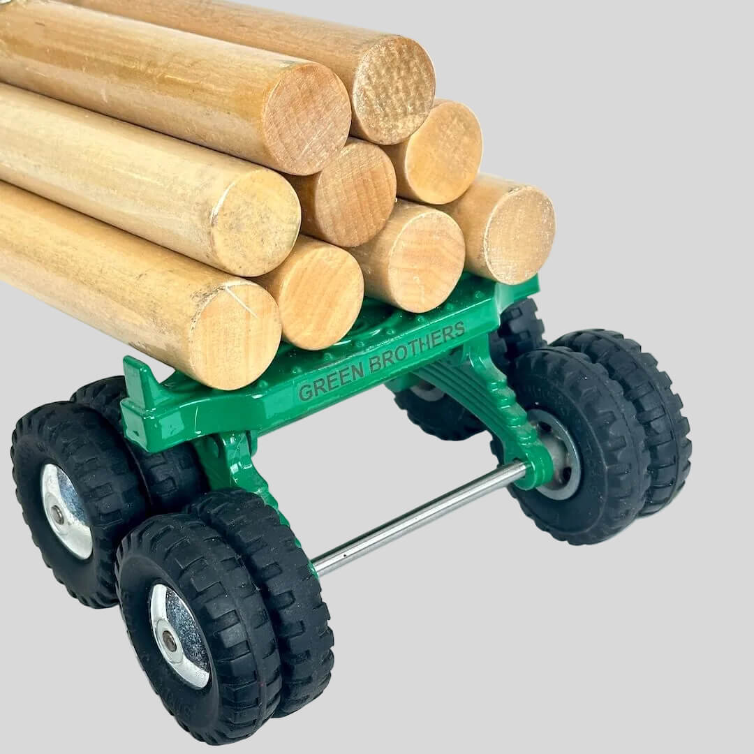 Toy truck with wooden logs on a white background