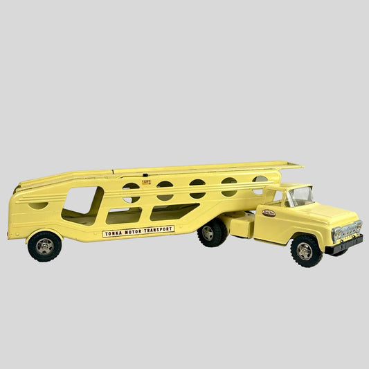 Yellow toy truck with a trailer on a white background