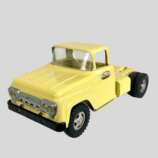 Yellow toy truck on a white background