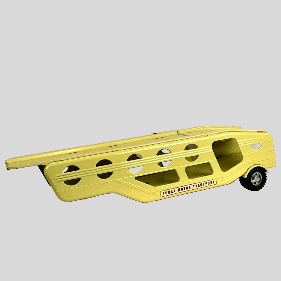Yellow toy truck with a trailer on a white background