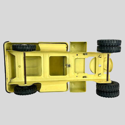 Yellow toy truck chassis with black wheels on a white background