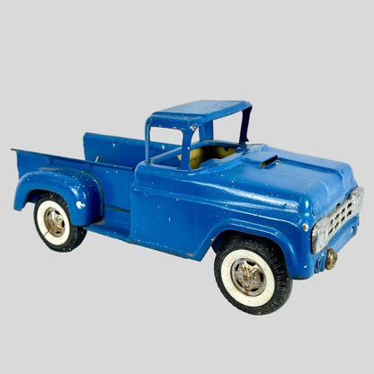 Blue model truck on a light gray background