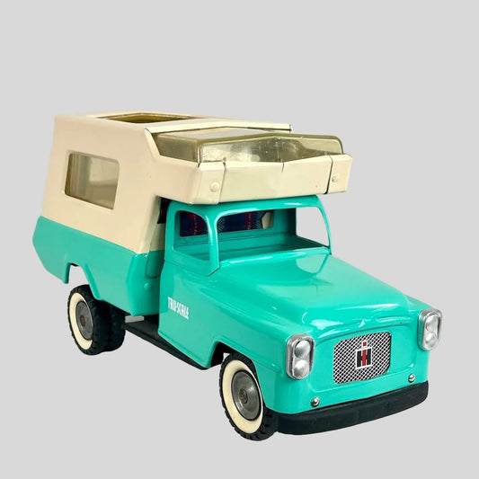 Model of a turquoise truck with beige roof on a white background