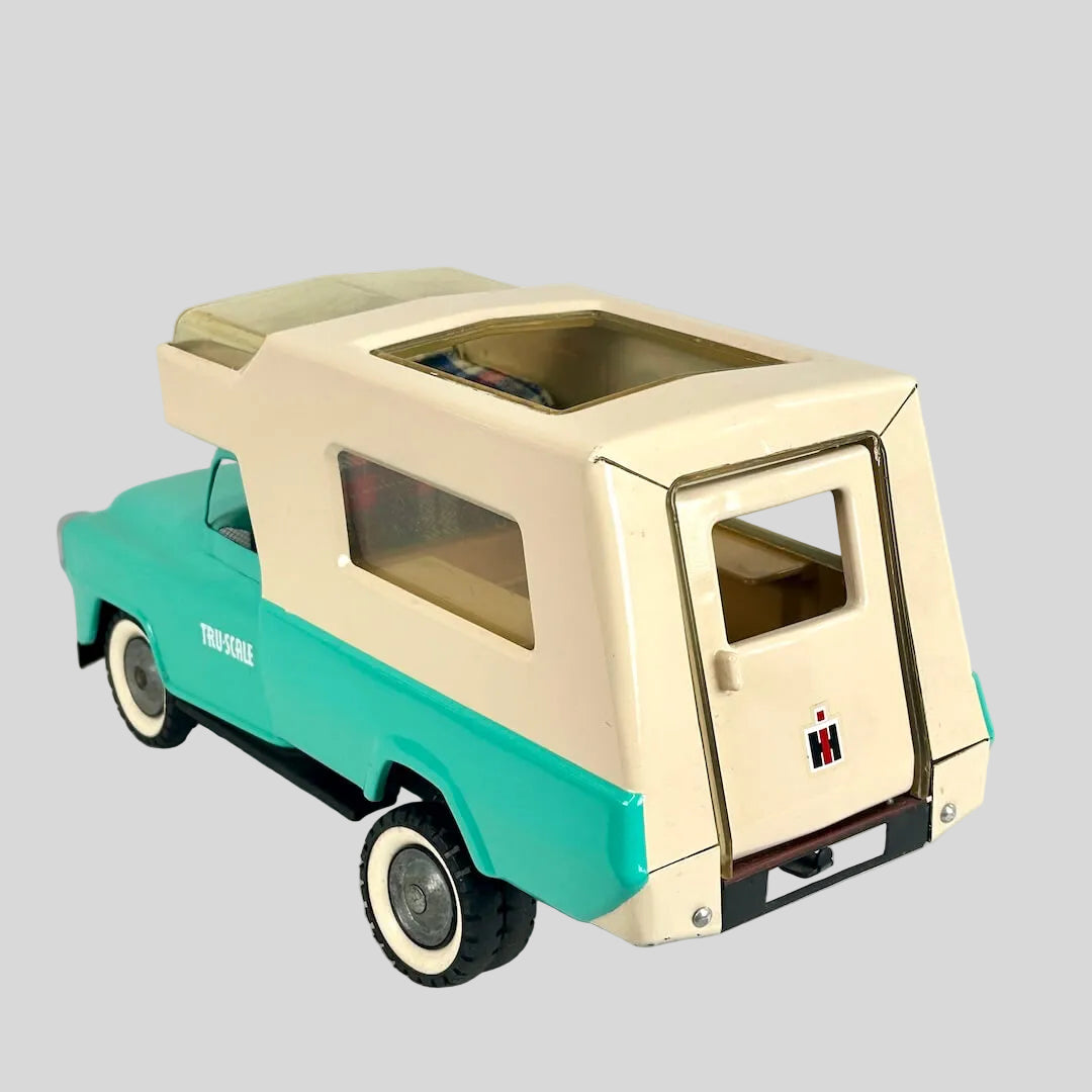 Model of a vintage truck with beige and teal colors on a light gray background