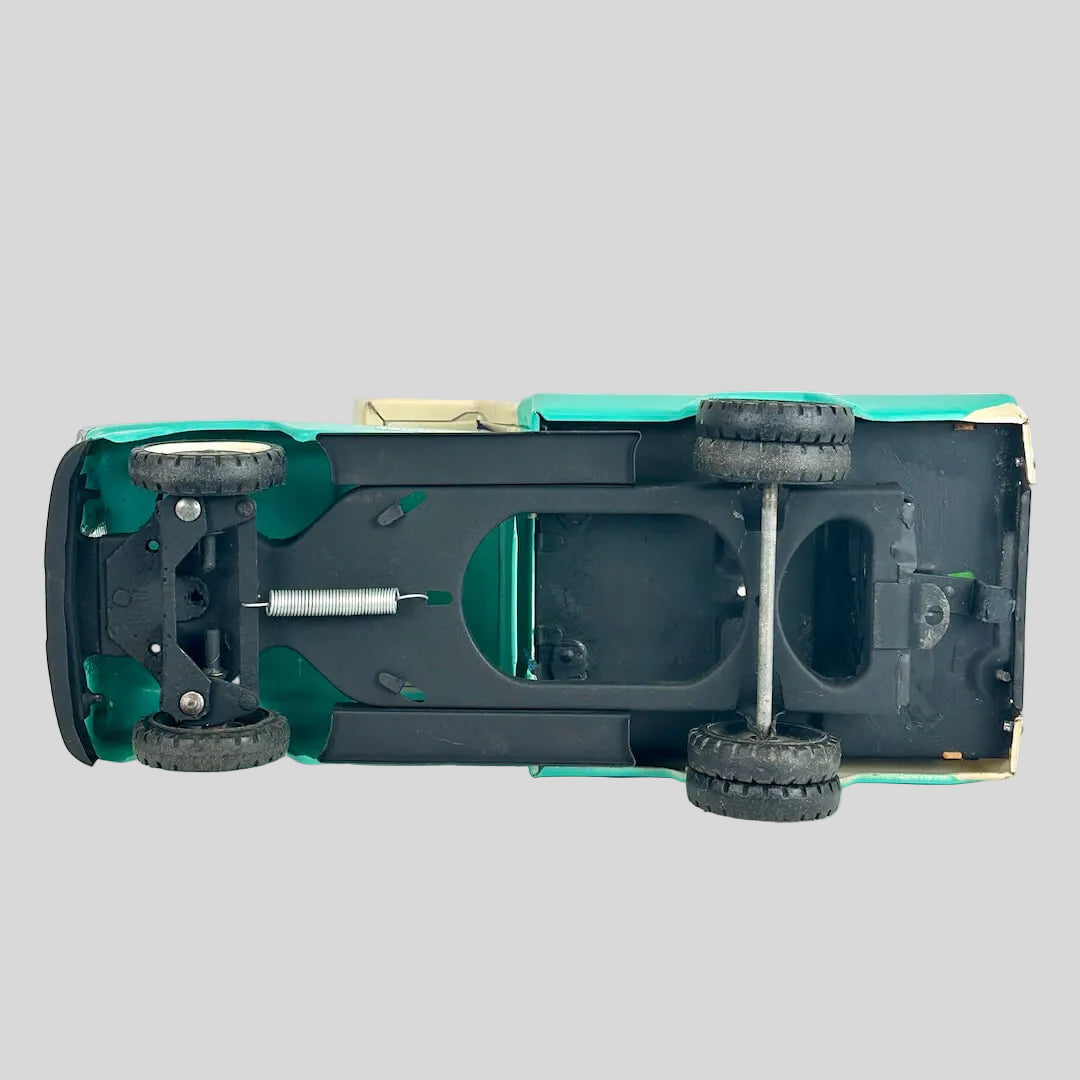Underside of toy truck with camper to see wheels and chassis. 