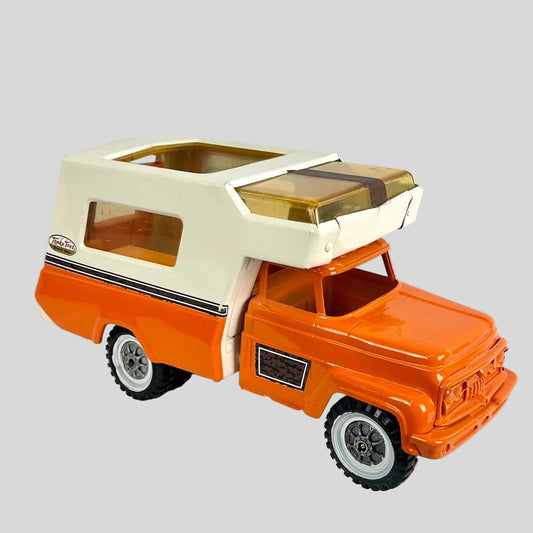 Toy camper truck with orange body and beige roof on a white background