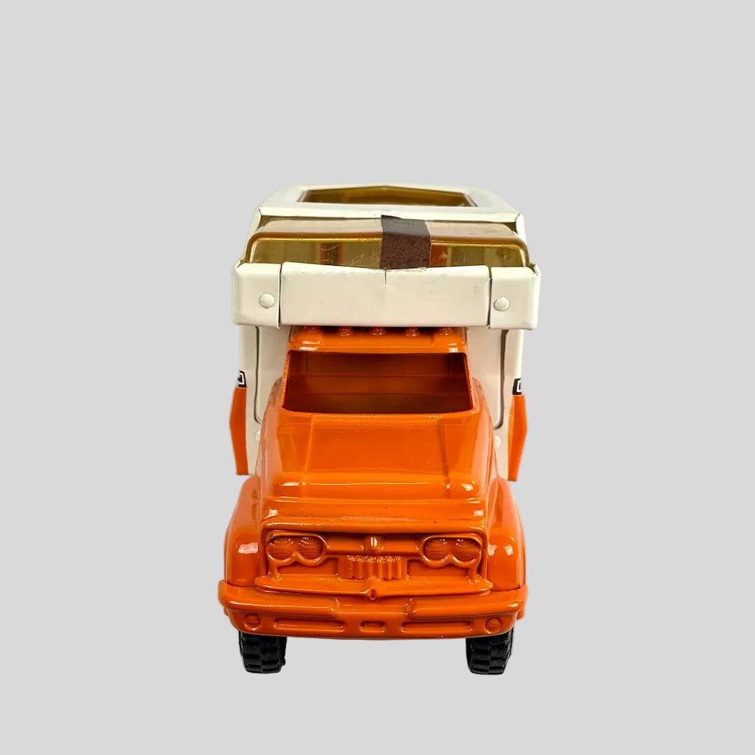 Toy truck with a beige camper top on a white background