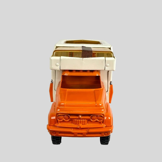 Toy truck with a beige camper top on a white background