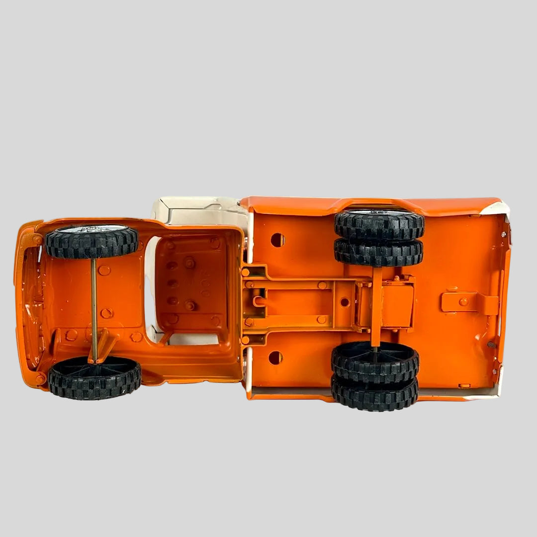 Orange toy truck with black wheels on a white background