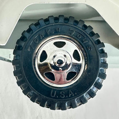 Toy truck wheel with chrome hub and 'U.S.A.' text on a white background
