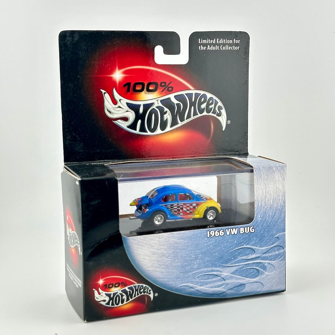 A Hot Wheels 1966 VW Bug diecast car in its original packaging, featuring a blue and yellow car with red and white flame decals.