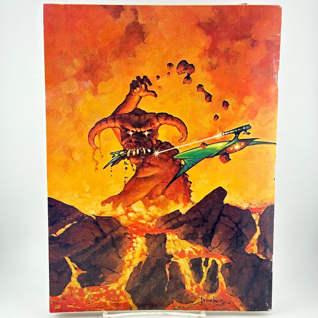 Back of magazine cover of flame monster swiping at spaceship in lava landscape. 