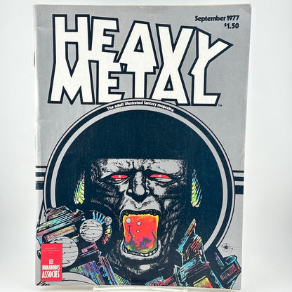 Silver magazine cover with illustrated image of man screaming in helmet under text, "Heavy Metal"