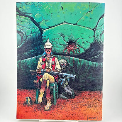 Back of magazine with illustration of man sitting with gun on his lap with an alien crouched behind him. 