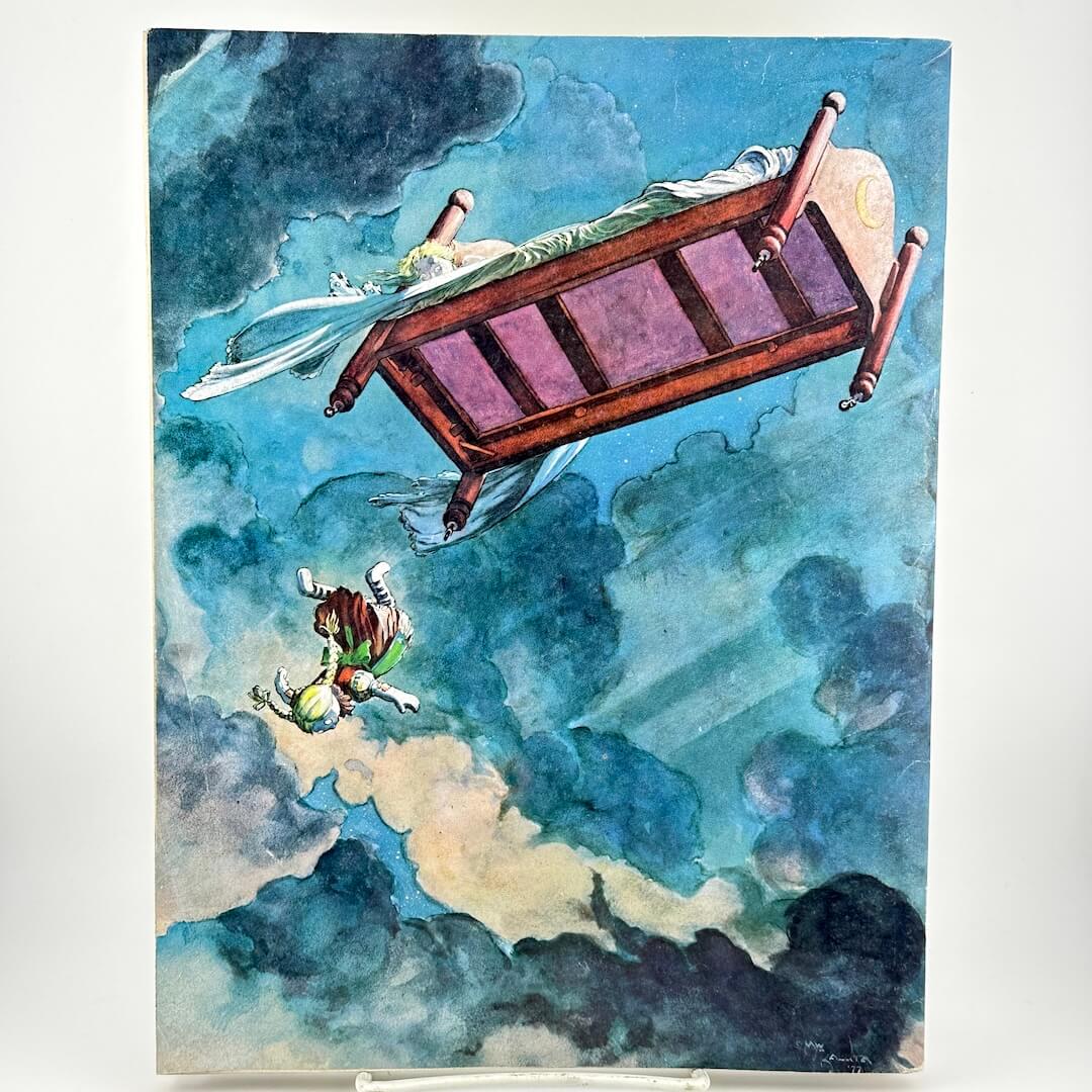Back cover of magazine with image of flying bed and falling robot girl in clouds. 