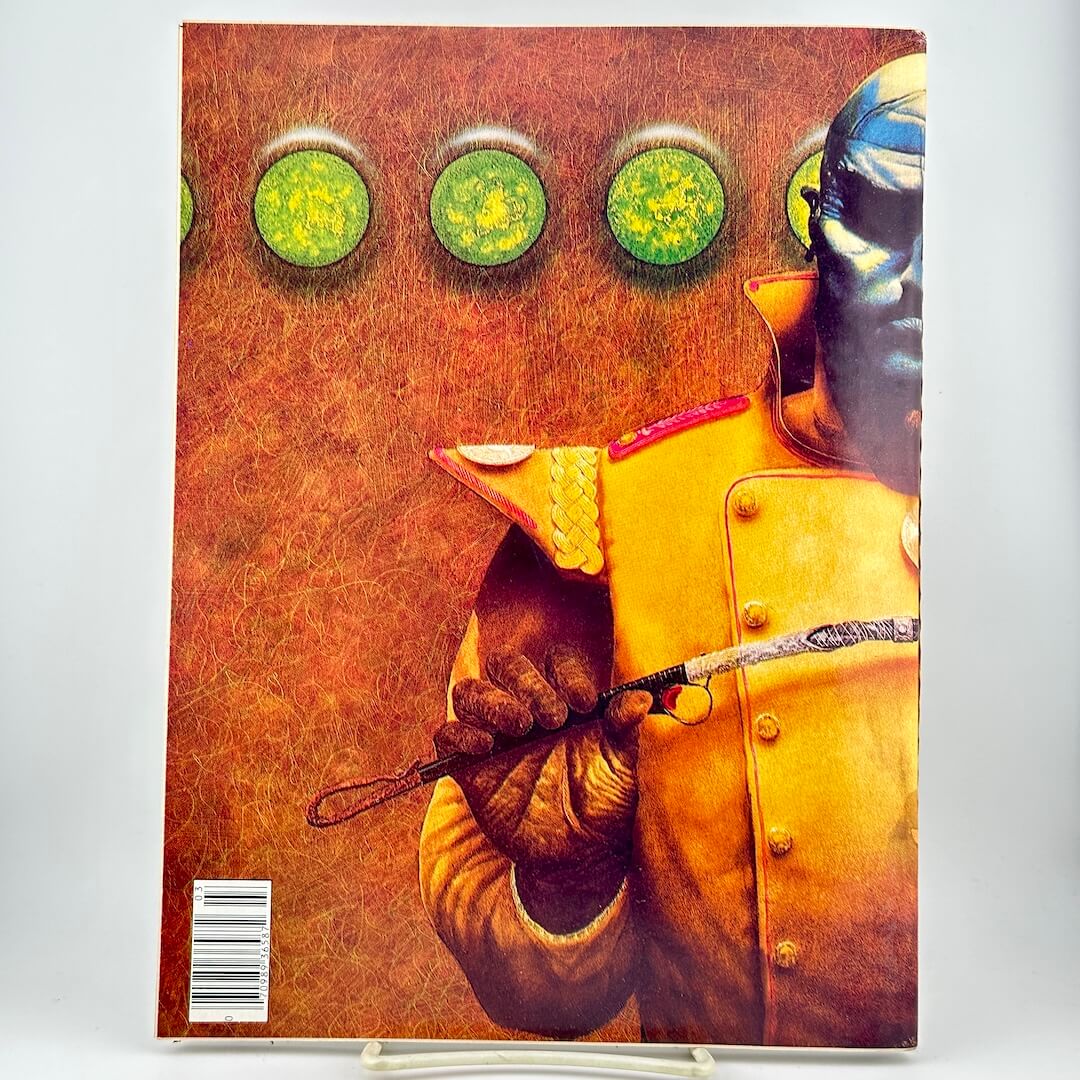 Back cover of Heavy Metal magazine with blue-faced humanoid in gold uniform on brown background. 