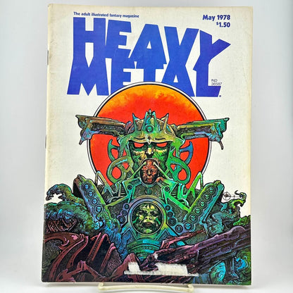 Heavy Metal magazine cover with futuristic illustration under large blue title, photographed on white background. 