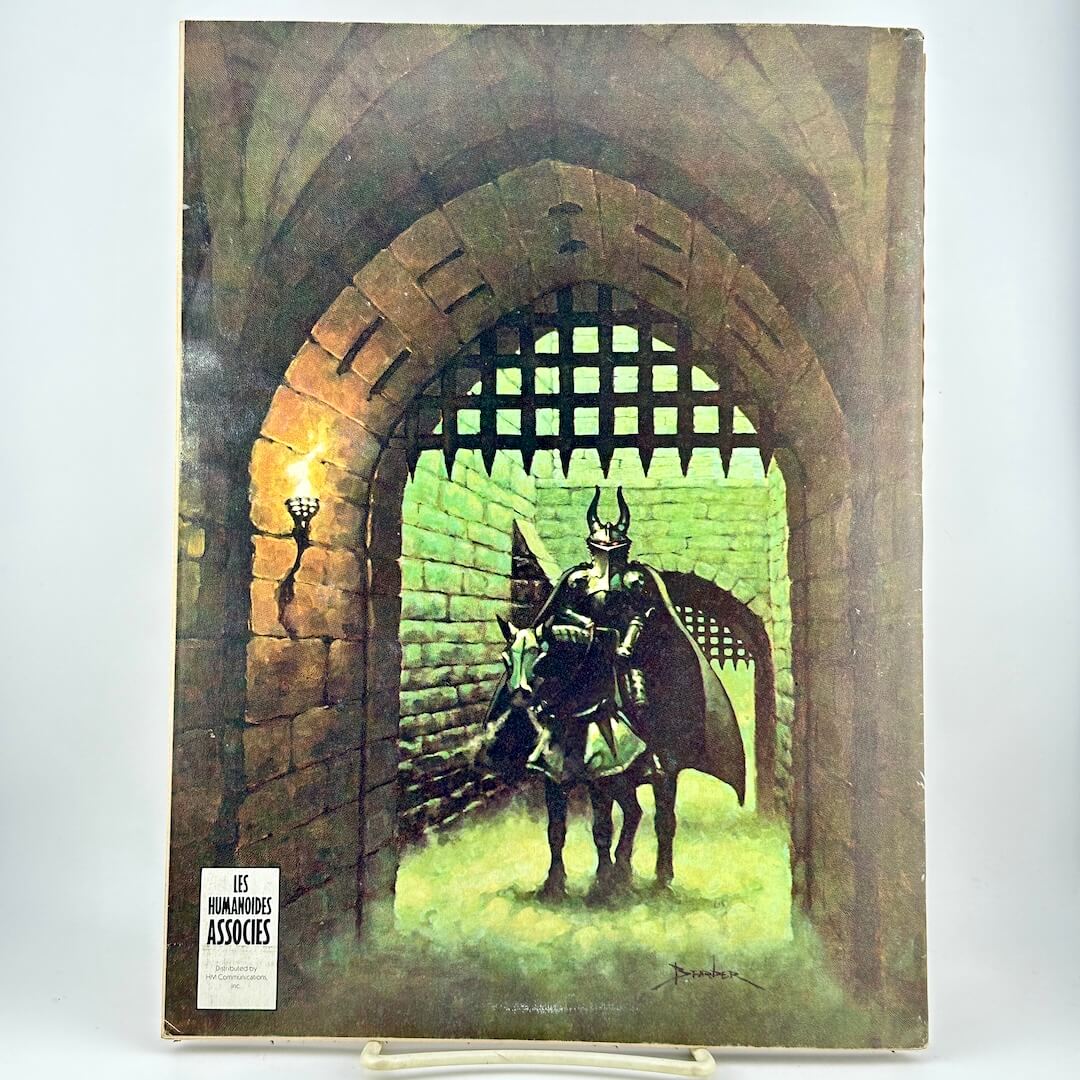 Back cover of magazine with horse-mounted person in armor behind a castle gateway. 