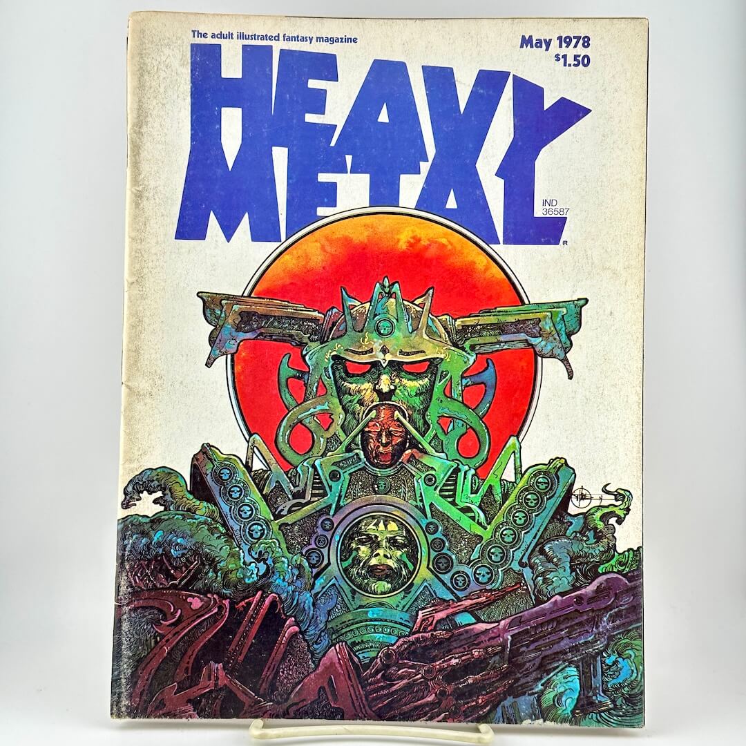 Heavy Metal magazine cover with futuristic illustration under large blue title, photographed on white background. 