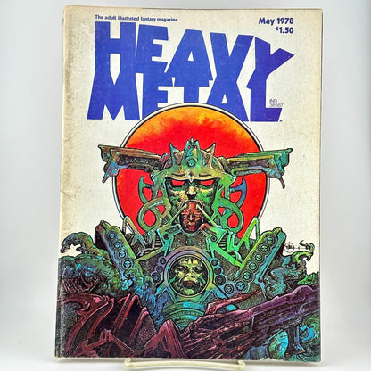 Heavy Metal magazine cover with futuristic illustration under large blue title, photographed on white background. 
