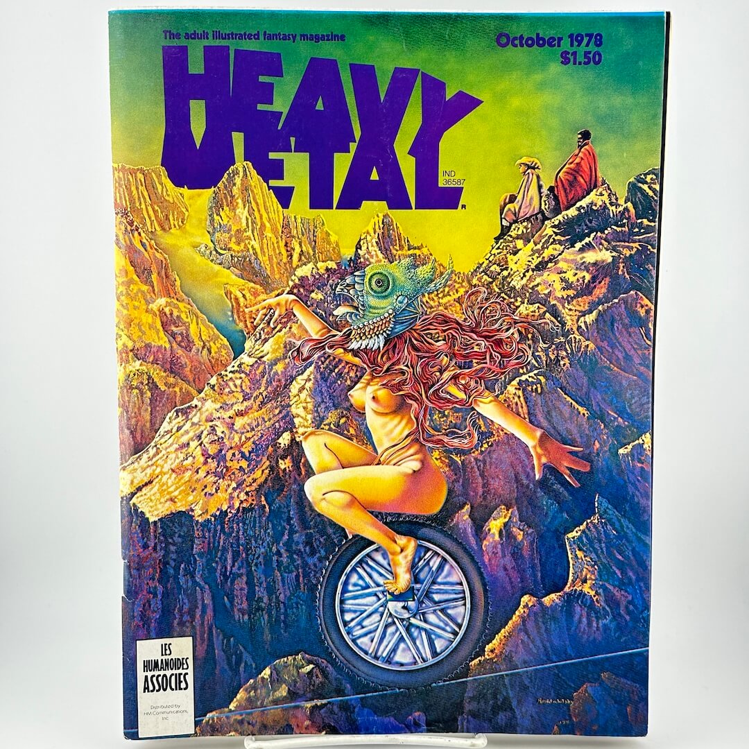 Magazine cover with text, "heavy metal" and masked woman riding unicycle on tightrope in mountains. 
