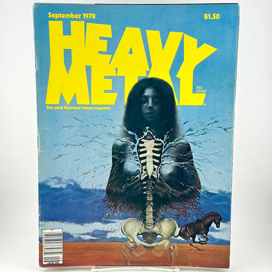 Magazine cover with illustration of woman opening chest to reveal bones with zebra in background. 
