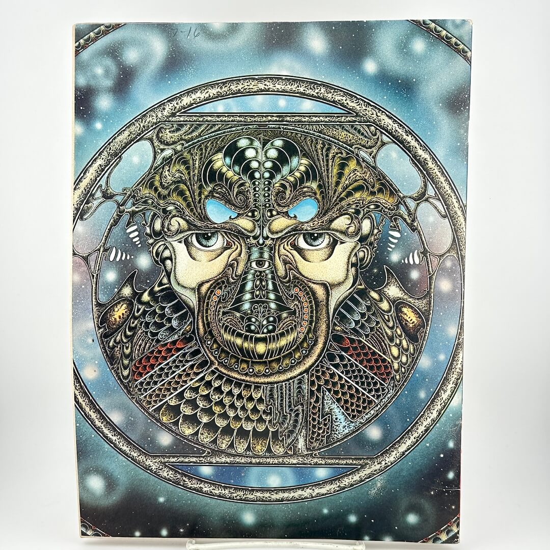 Back cover of magazine with intricate illustration of face in geometric patterns. 