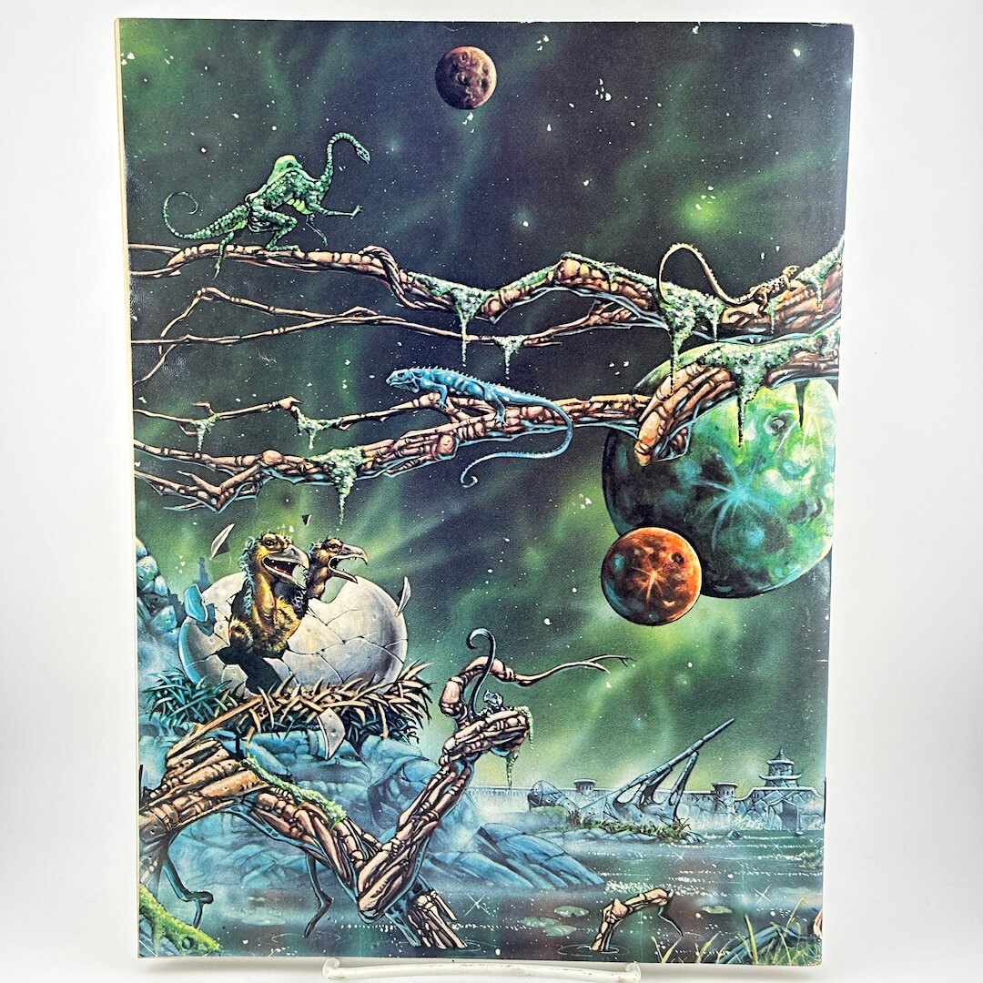 Back cover of magazine with futuristic landscape and creature emerging from cracked egg. 