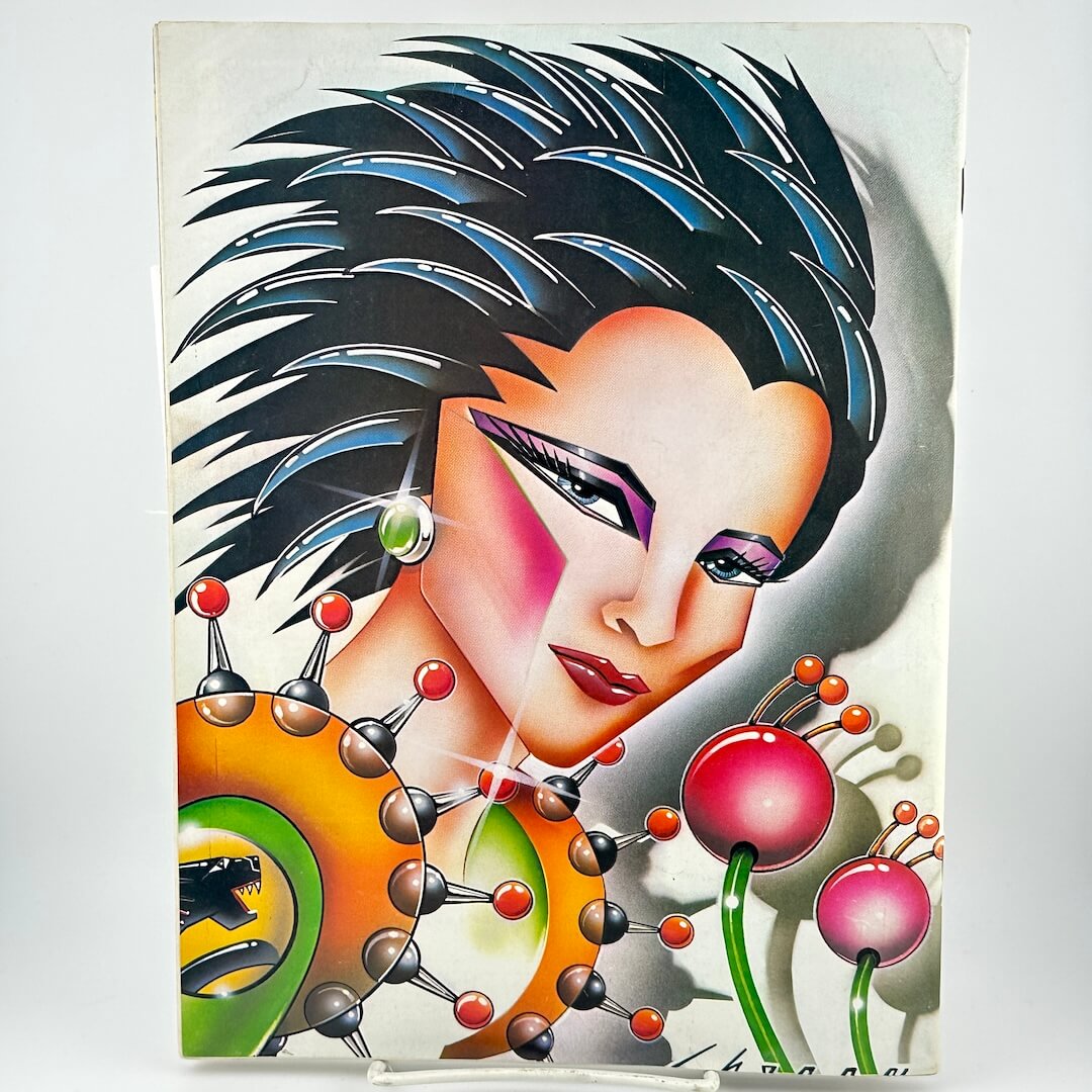 Back cover of magazine with futuristic woman head with spiky hair. 