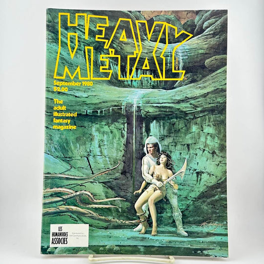 Heavy Metal magazine featuring its logo & cover art of a fantasy scene with two characters in a green cave-like environment. 