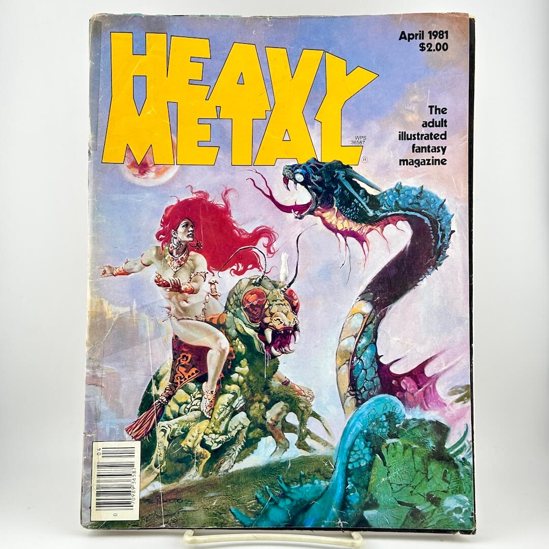 Heavy Metal magazine with fantasy artwork of a woman riding a green creature with a blue serpent-like monster in the back