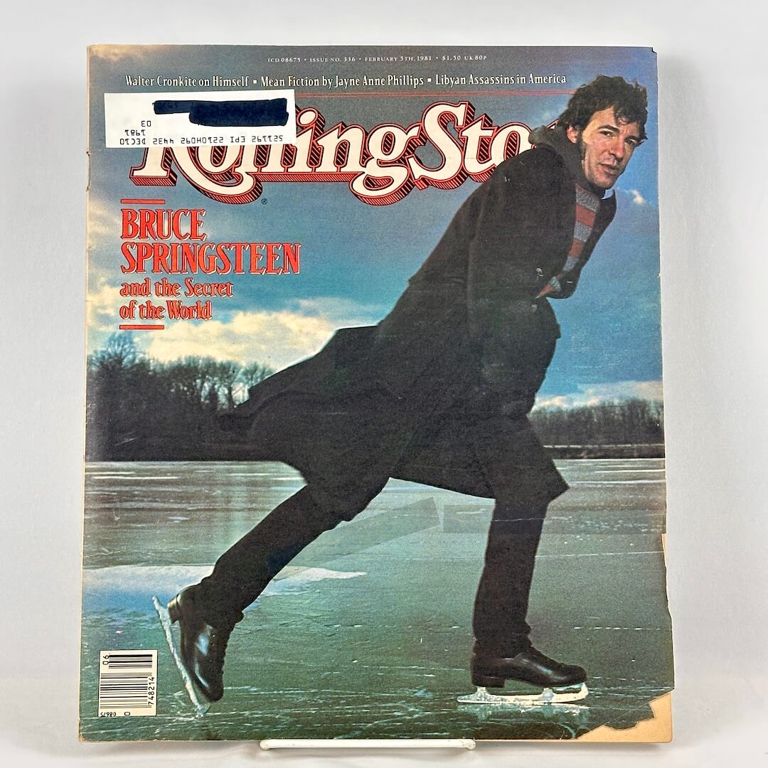A vintage issue of Rolling Stone magazine featuring Bruce Springsteen  ice skating on the cover. 