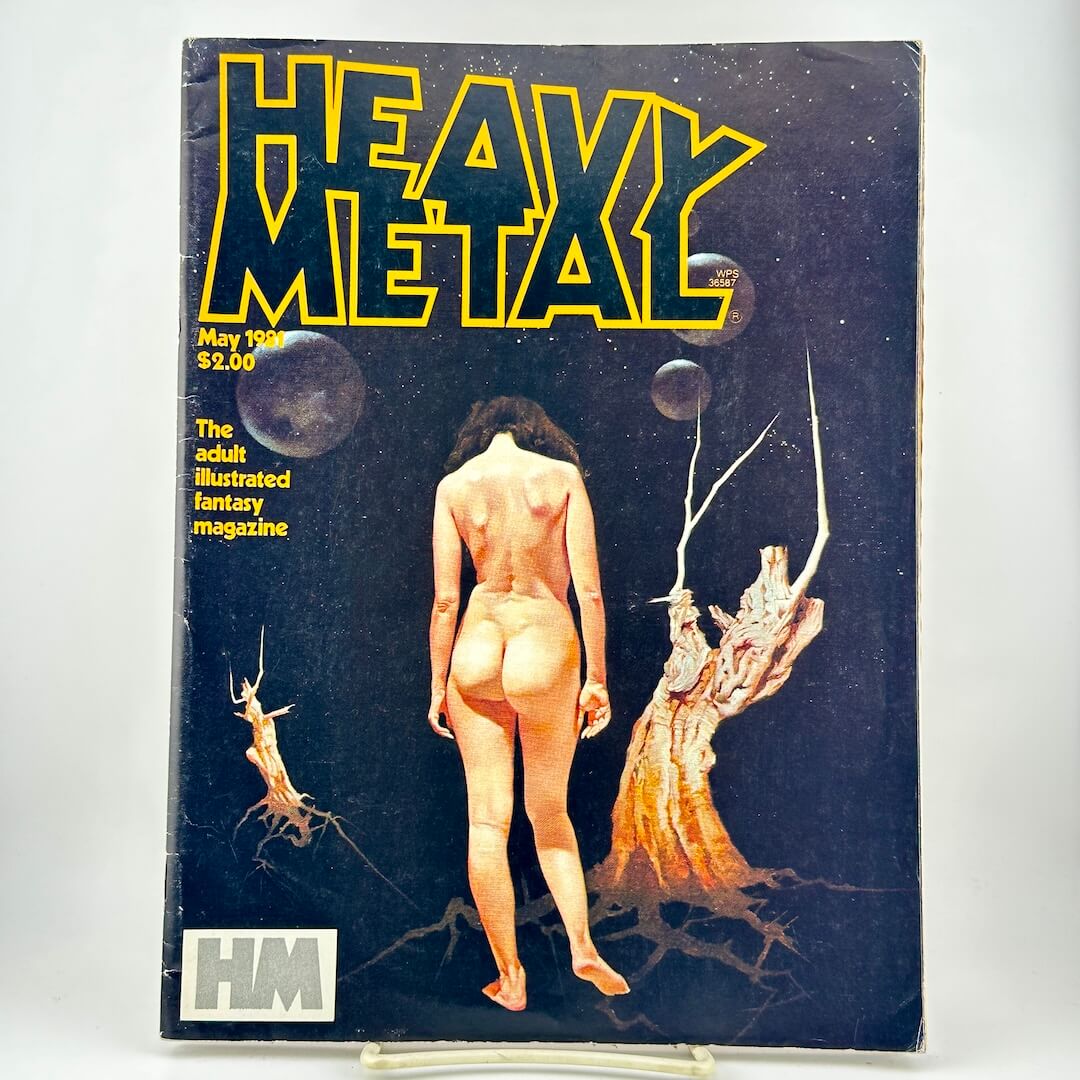 Heavy Metal magazine cover with nude woman on dark background featuring dead trees and night sky. 