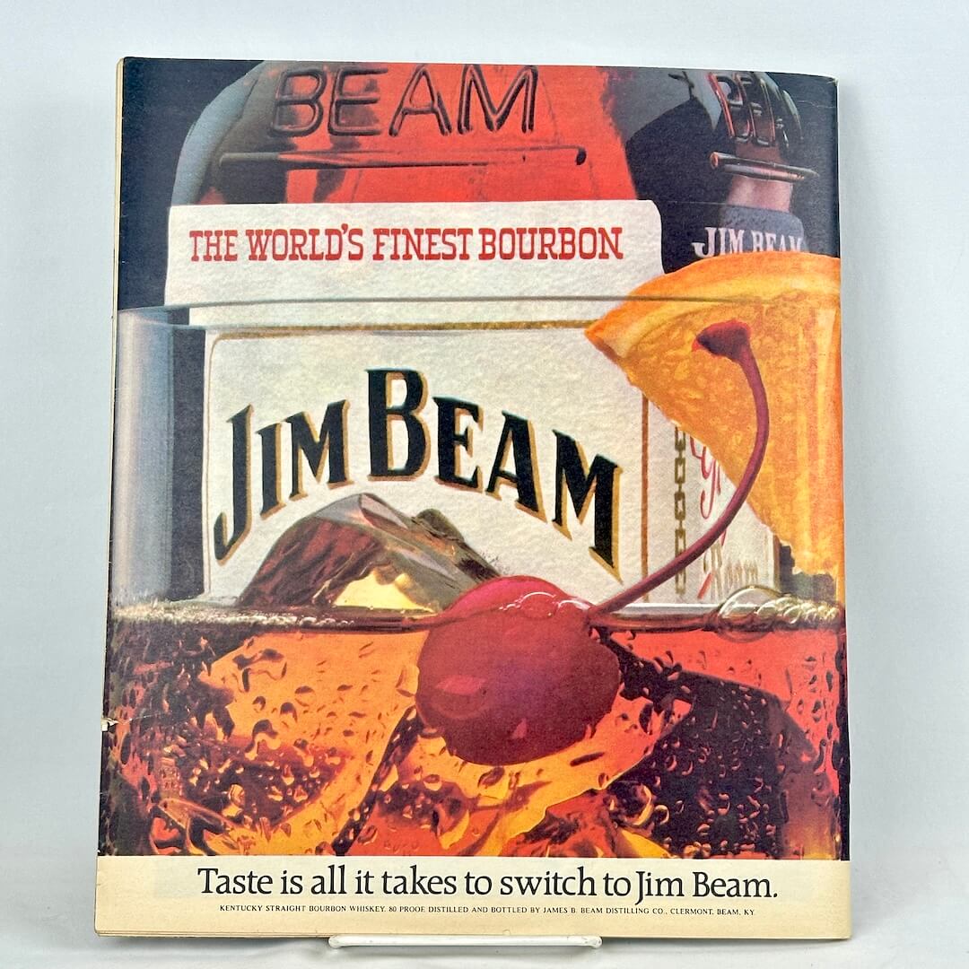 A vintage Jim Beam advertisement on back cover, featuring a bottle, and a close up of a cocktail. 