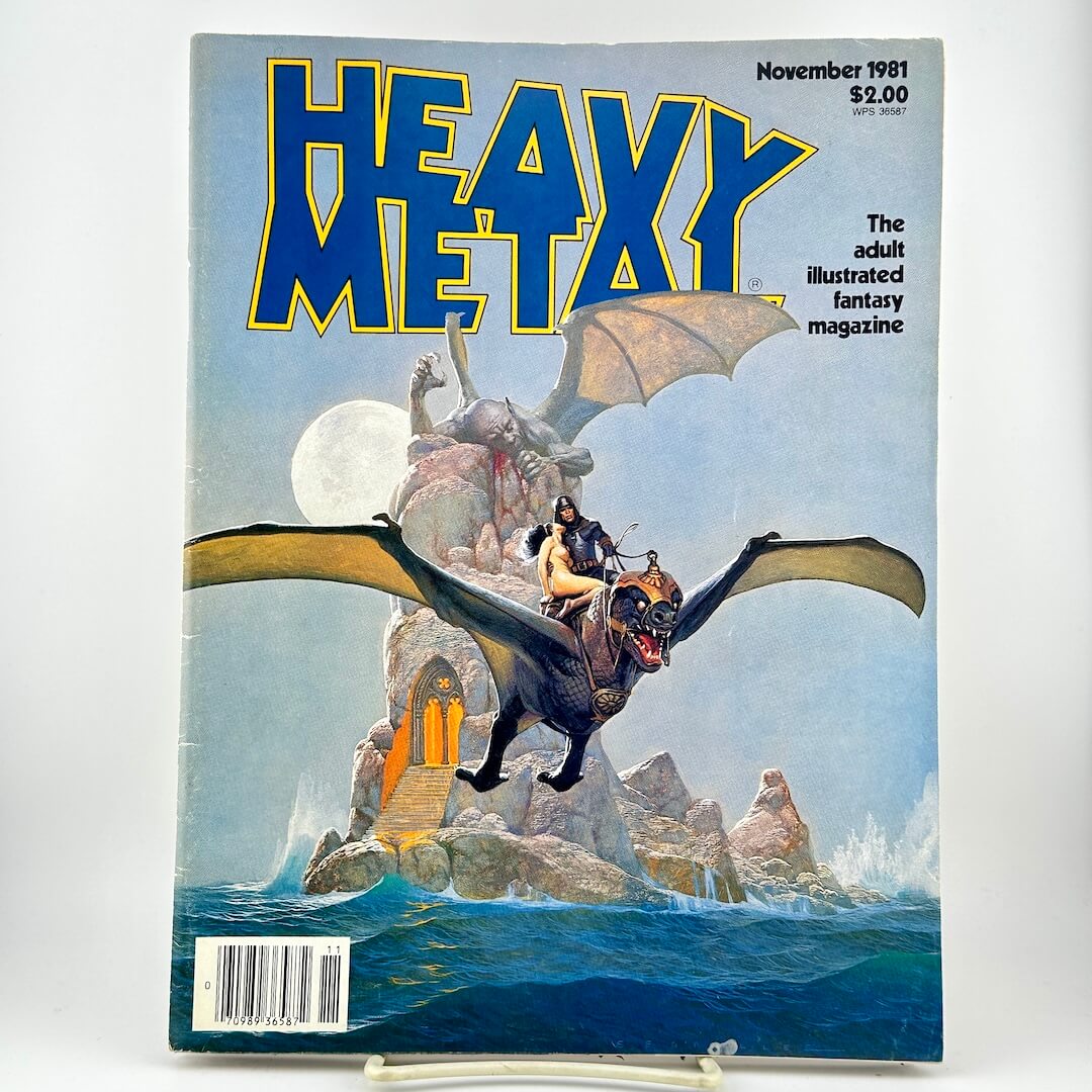 Heavy Metal magazine featuring fantasy cover art of a rider on a dark dragon flying over rocky seas under a full moon. 