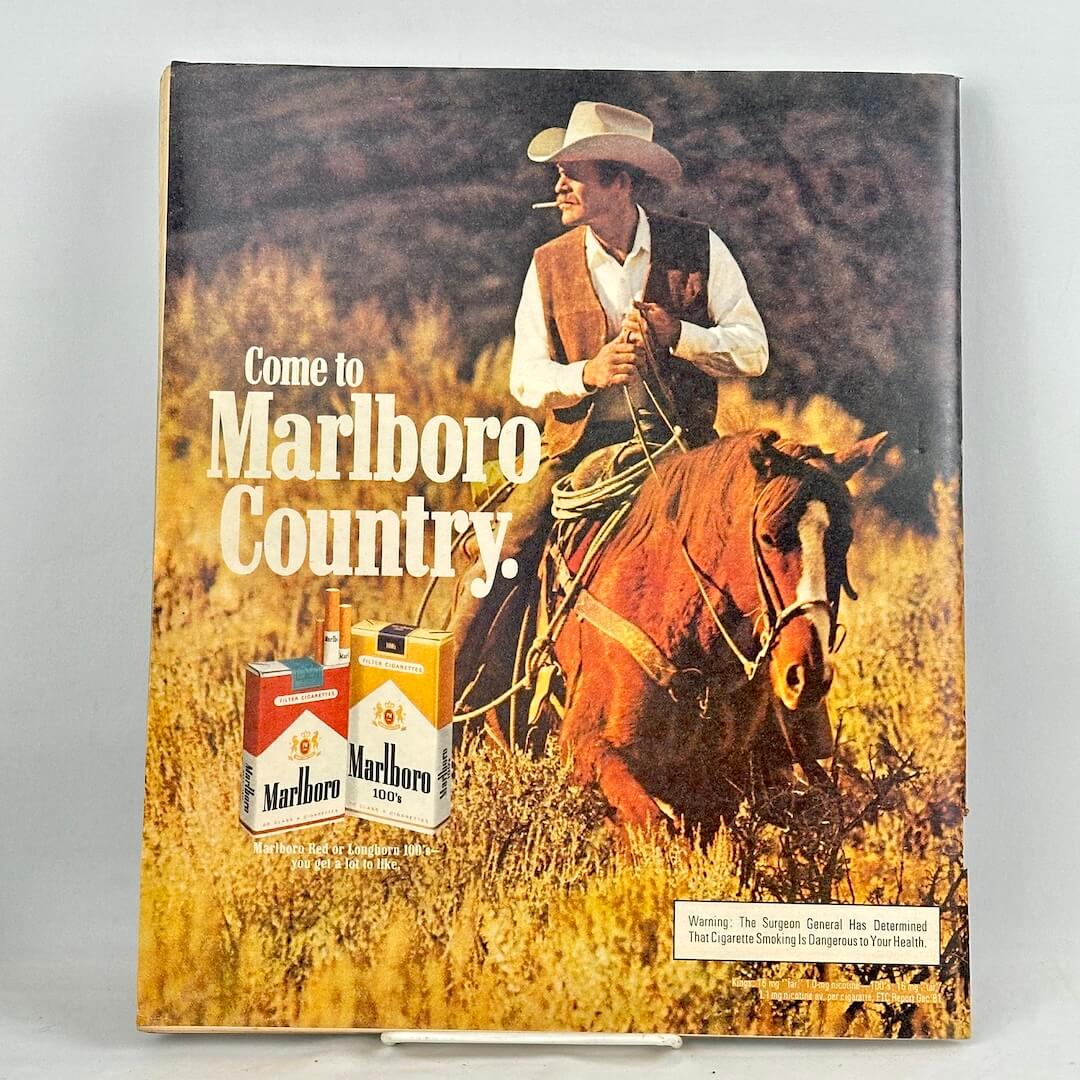 Back cover of magazine featuring full size Marlboro ad with a smoking, horse riding cowboy as main image. 