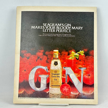 Back cover of magazine with full page ad for Seagram's gin featuring a bunch of tomatoes with a bottle in front. 