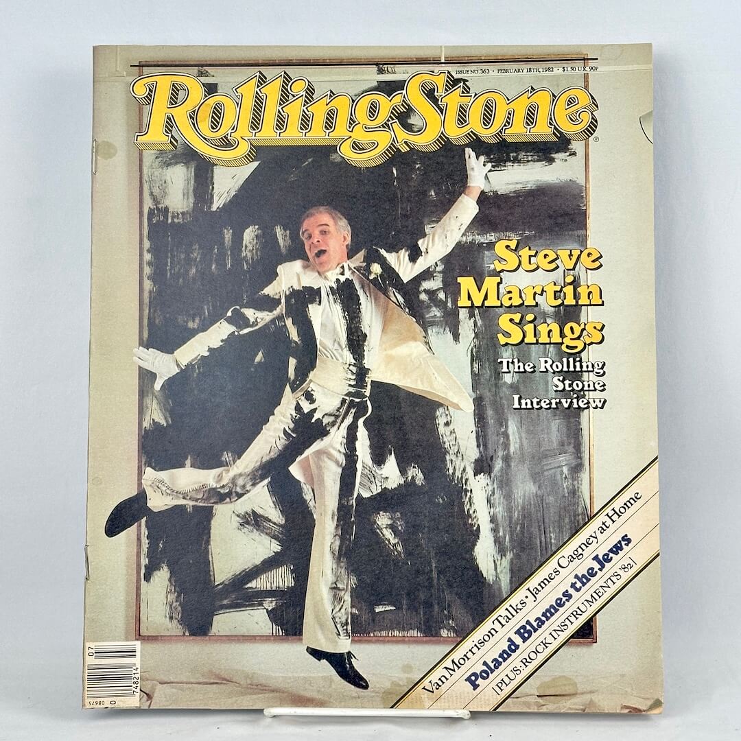 Vintage Rolling Stone magazine with Steve Martin in painted suit striking dramatic pose in front of abstract background. 