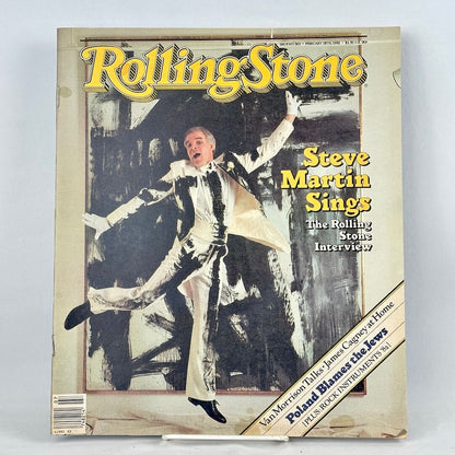 Vintage Rolling Stone magazine with Steve Martin in painted suit striking dramatic pose in front of abstract background. 