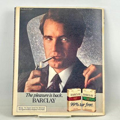 Back cover of magazine featuring a Barclay cigarettes ad with man in suit lighting cigarette as main image. 