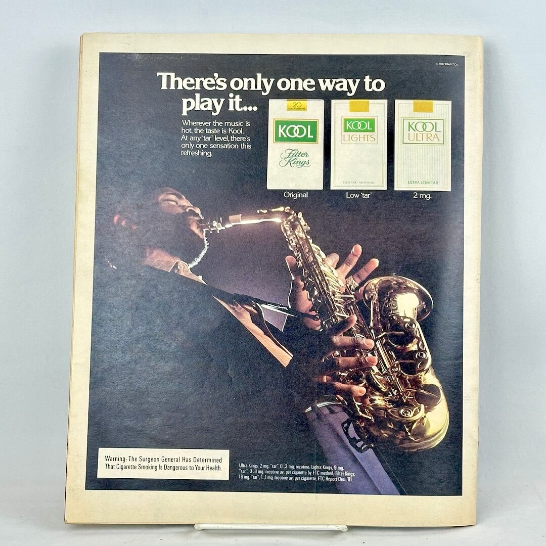 Back cover of magazine featuring a full page ad for KOOL cigarettes featuring man playing a saxophone. 