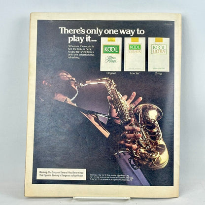 Back cover of magazine featuring a full page ad for KOOL cigarettes featuring man playing a saxophone. 