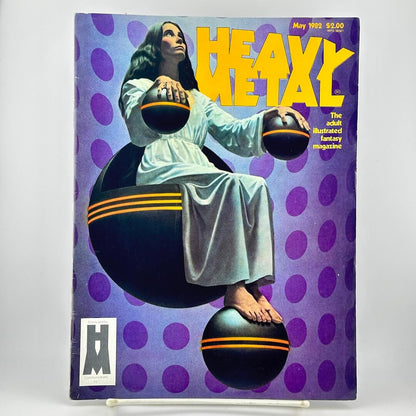 Heavy Metal Magazine cover featuring woman in white robe sitting on floating black balls with purple background. 