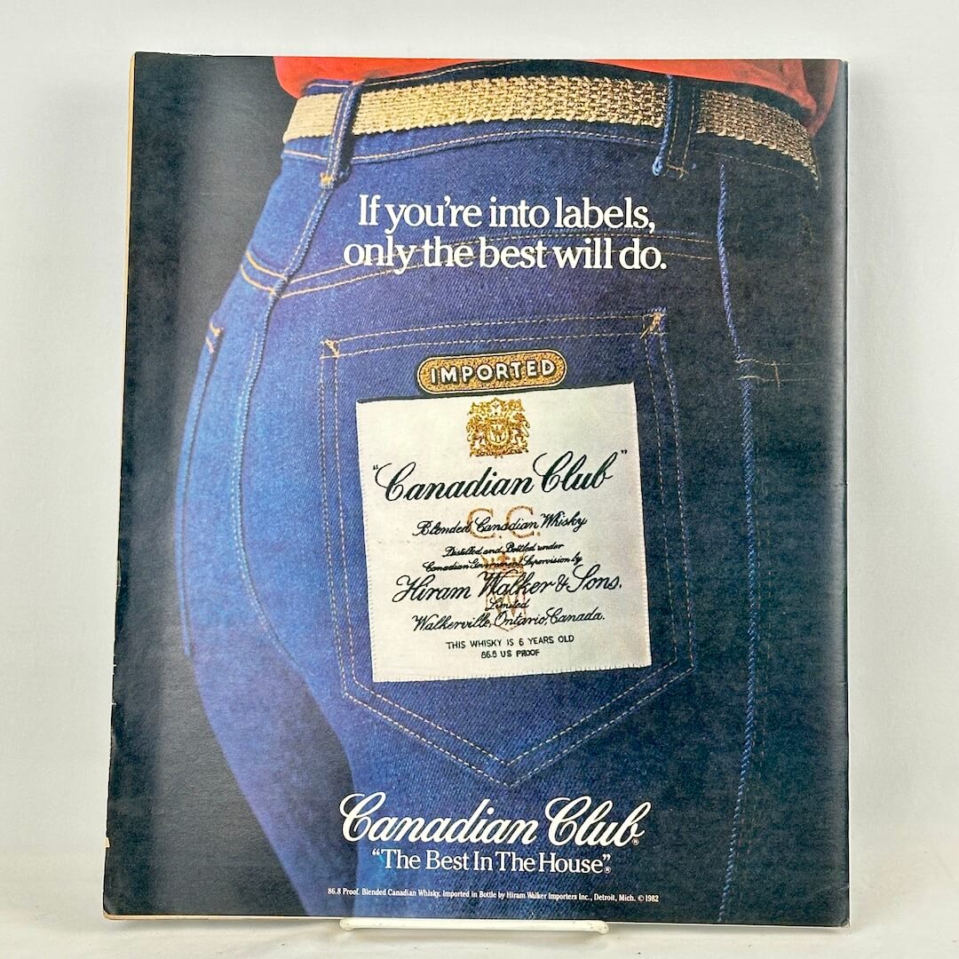 Back cover of magazine with full page ad for Canadian Club whiskey featuring an image of back pockets of someone's jeans.