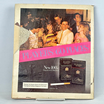 Back cover of magazine with full page ad for Players cigarettes featuring an image of people at a party, some smoking. 