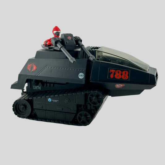 Black tank-like vehicle with red decals & two large guns on turret manned by action figure in red with silver visor. 