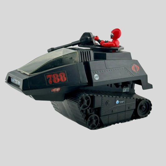 Black tank-like vehicle with red decals & two large guns on turret manned by action figure in red with silver visor. 