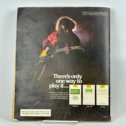 Back cover of magazine with full page ad for KOOL cigarettes featuring photo of man playing electric guitar. 